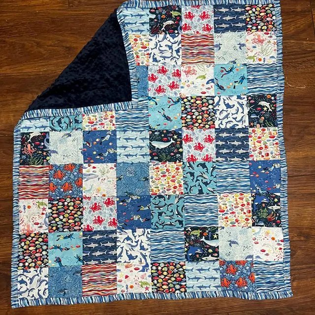 Customer creation by Monique — baby quilt with navy minky backing